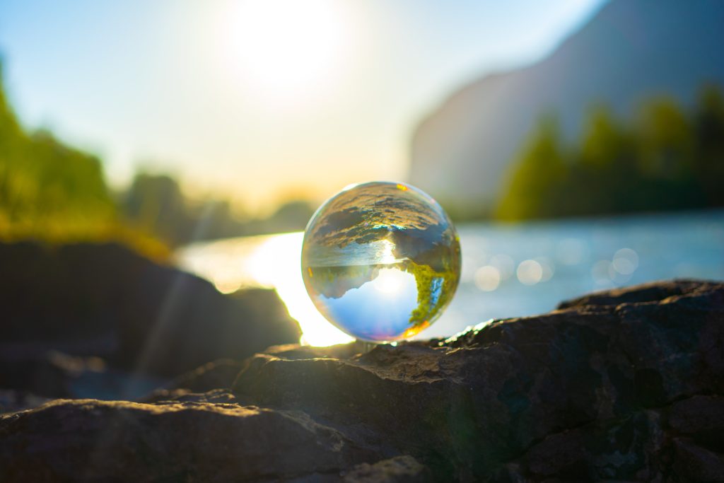 A glass ball sitting on a rock, resembling the globe.